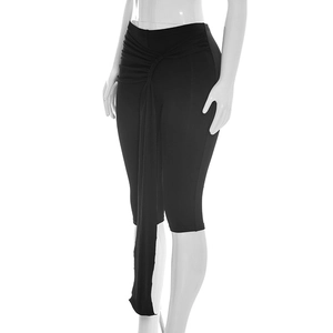 Detail view of high waist black capri pants featuring ruched design and decorative drape