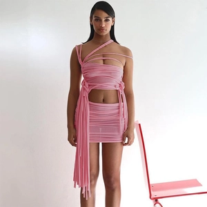 Detail of pink mesh tube top with cross-wrap straps and matching mini skirt