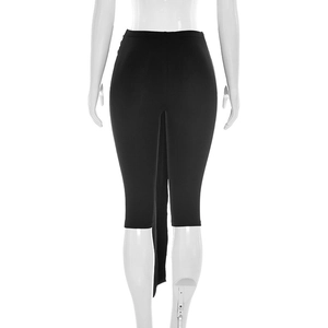 Detail of high waist black slim trousers with a decorative long streamer at the back