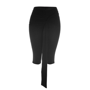 Detail of high-waisted black fitted capri pants with front pleats and draped ribbon trim