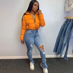 Fashionable orange glossy cropped puffer jacket with drawstring and ripped jeans styling
