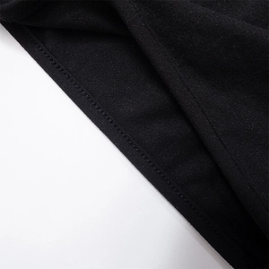 Close-up of black knitted fabric texture showing premium double-stitched reinforced seams