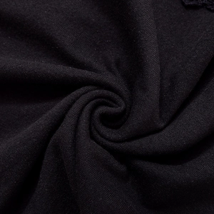 Detailed macro view of black ribbed knit fabric with delicate lace trim on the edges