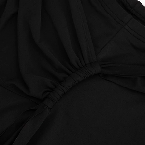 Macro shot of black pleated fabric detailing and fine stitching on high-waist cropped pants