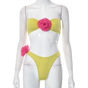 Detail of neon yellow bikini with 3D pink rose flower accents on tube top and bottom