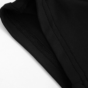 Detail of high-waist black casual pants showing double-needle stitching and ribbed texture