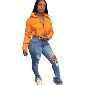 Detail view of bright orange puffer jacket with stand collar and metal zipper closure