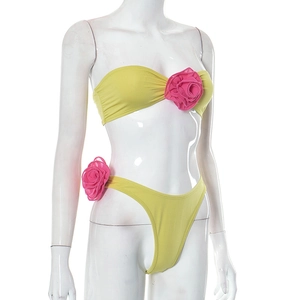 Detail of lime green and pink bikini set featuring large 3D fabric rose flower accents