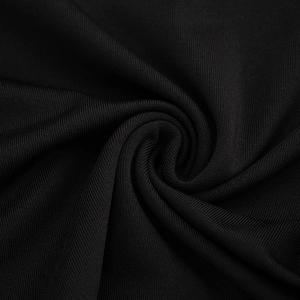 Macro shot of black pleated fabric showing soft ribbed texture and elegant drape detail