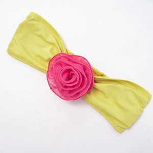 Detail of neon yellow bandeau top featuring a large hot pink fabric 3D rose accent