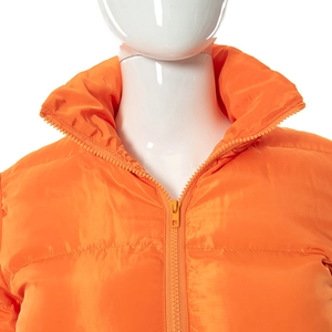 Detail of high-gloss orange puffer jacket featuring a stand-up collar and resin zipper closure