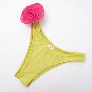 Detail of neon green bikini bottom featuring a large pink 3D mesh floral decoration