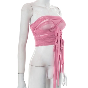 Close-up of pink mesh crop top featuring criss-cross wrap design and hanging fringe ties