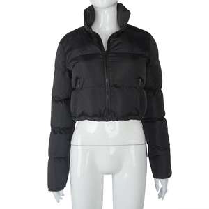 Detail of black cropped puffer jacket featuring high collar and zip pockets