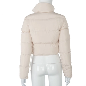 Detail view of the quilted texture and stand collar on this beige cropped puffer jacket