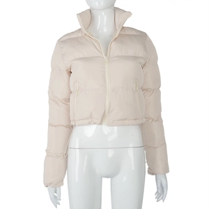 Detail view of cream puffer jacket featuring high stand collar and secure zipper pockets