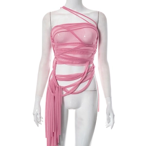 Detail of pink mesh strapless top featuring crisscross lace-up straps and long fringe trim