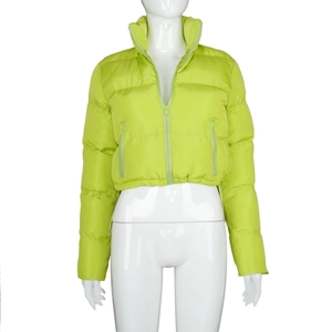 Detailed view of the bright neon green quilted texture and zipper of the cropped puffer jacket