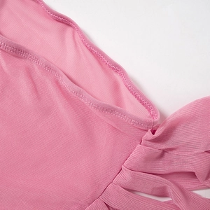 Close-up of pink mesh fabric showing fine mesh structure and professional edge stitching