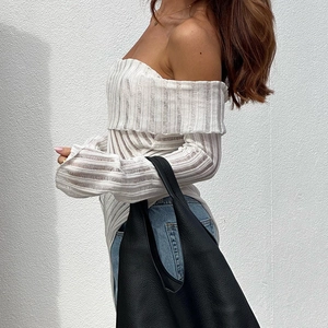 Detail of off-shoulder long sleeve knit top in white ribbed fabric and slim fit design
