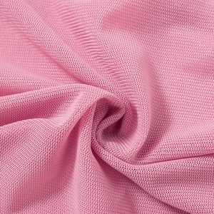 Detail of pink mesh knit fabric showing a breathable warp-knitted structure and soft texture