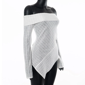 Detail of white off-shoulder top showing vertical ribbed texture and asymmetric hemline