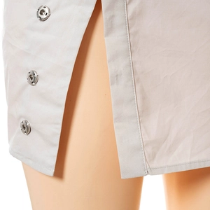 Detail showing side slit with silver metal snap buttons on high waist summer skirt