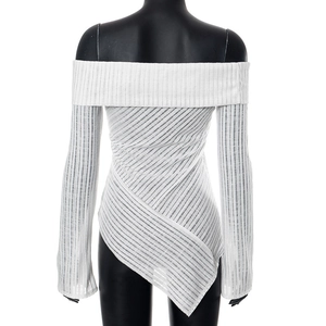 Detail view of white off-shoulder long sleeve top with ribbed texture and asymmetrical hem