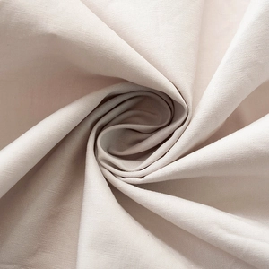 Detail shot of cream high-waist skirt fabric featuring elegant spiral floral folding
