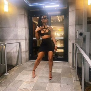 Sexy black two-piece set with cutout lace-up top and bodycon mini skirt for party