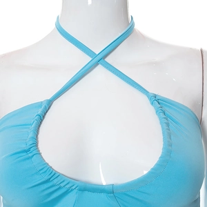 Detailed view of light blue halter neck top with crisscross straps and hollow out design
