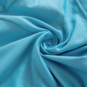 Detailed macro view of lake blue ribbed knit fabric texture and soft material drape