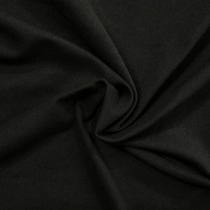 Close-up of black diagonal twill fabric texture with high drape and elegant pleats