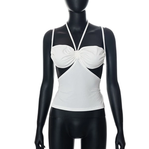 Detail of white halter neck top with ruching and side cutout on black mannequin