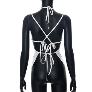 Detail view of the crisscross lace-up back and tie knots on a white backless halter top