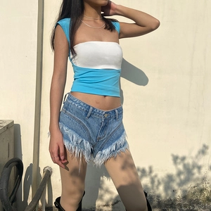 Slim-fit cutout back top with blue denim shorts featuring bold white fringe tassels