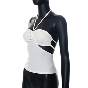 Detail view of white halter crop top featuring ruched twist front and cutout lace-up sides