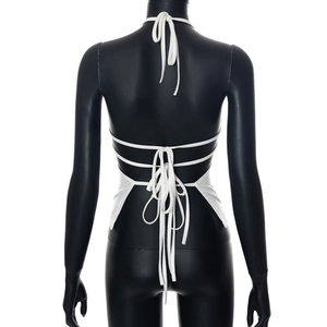Detail view of white halter top featuring an open back and crisscross tie-up design