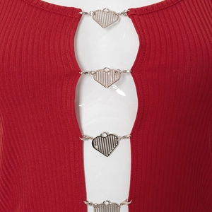 Detail of red ribbed knit top featuring silver metal heart buckles and chest cutout