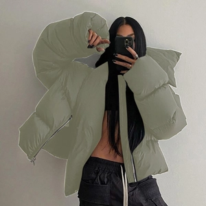 Detailed view of the olive green padded jacket with high collar and metal zipper