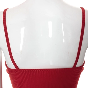 Back view of red ribbed knit crop top with spaghetti straps and hollow heart detail