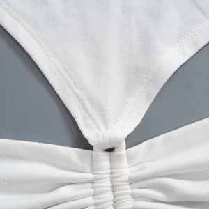 Macro view of white ruched fabric with double-needle stitching and detailed textures