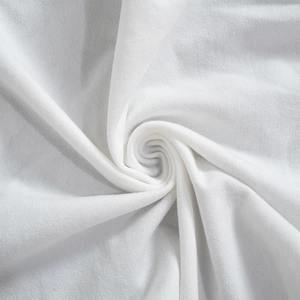 Macro detail of white knitted cotton fabric with fine texture and soft spiral draping
