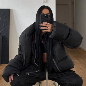 Women's black quilted puffer jacket with high neck and zip closure in streetwear style