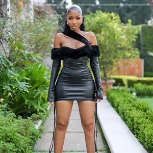 Detail of faux leather mini dress featuring a plush fur trim neckline and stylish strap
