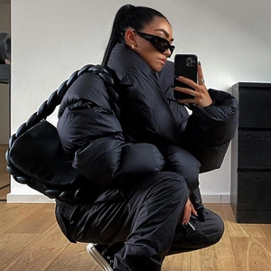 Mirror selfie showing details of a black oversized high collar puffer jacket with snap buttons