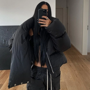 Detail of high collar puffer jacket with snap zipper and matching cargo pants set
