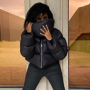 Close-up of black padded puffer jacket with high neck and zip closure in streetwear style