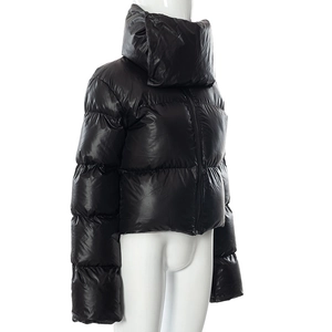 Detail of high-collar shiny black quilted jacket with windproof zipper and glossy finish