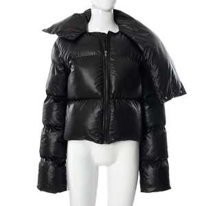 Detail of black puffer jacket showing high neck collar and glossy quilted texture